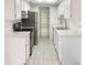 View of kitchen with white cabinets, stainless steel appliances, and pantry at 16635 N Cave Creek Rd # 228, Phoenix, AZ 85032