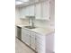 White kitchen cabinets, double sink, and stainless steel dishwasher at 16635 N Cave Creek Rd # 228, Phoenix, AZ 85032