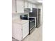 Kitchen features white cabinets, stainless steel appliances, and tile floors at 16635 N Cave Creek Rd # 228, Phoenix, AZ 85032