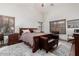 Main bedroom with a large bed and wood furniture at 18208 W Skyline Dr, Surprise, AZ 85374