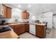 Kitchen with wood cabinets, dishwasher, and breakfast bar at 18208 W Skyline Dr, Surprise, AZ 85374