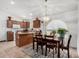 Kitchen with island, wood cabinets, and adjacent dining area at 18208 W Skyline Dr, Surprise, AZ 85374