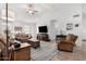 Spacious living room with tiled floors and comfortable furniture at 18208 W Skyline Dr, Surprise, AZ 85374