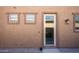 Exterior back door with glass panel and wall lights at 2033 W Burnside Trl, Phoenix, AZ 85085