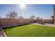 Landscaped backyard with artificial turf and patio at 2033 W Burnside Trl, Phoenix, AZ 85085