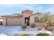 Single-story home with a two-car garage and desert landscaping at 2033 W Burnside Trl, Phoenix, AZ 85085