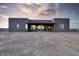 Modern gray home with a covered patio and sliding glass doors leading to a spacious dirt backyard at 24301 N 194Th Ave, Surprise, AZ 85387