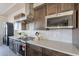 This modern kitchen features stainless steel appliances, quartz countertops, and custom cabinets providing a functional and stylish space at 24301 N 194Th Ave, Surprise, AZ 85387
