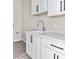 Bright laundry room with white cabinets and gray flooring at 24301 N 194Th Ave, Surprise, AZ 85387