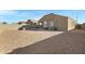 Backyard with desert landscaping and featuring neutral colored rock at 25264 W Burgess Ln, Buckeye, AZ 85326