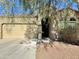 House exterior with a two-car garage and mature tree in front at 25264 W Burgess Ln, Buckeye, AZ 85326