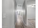 Hallway with vinyl floors, leading to carpeted rooms and featuring neutral-toned walls at 25264 W Burgess Ln, Buckeye, AZ 85326