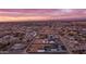 Scenic aerial view of a neighborhood at sunset, showcasing a home with a pool and spacious lot at 25916 S 198Th St, Queen Creek, AZ 85142