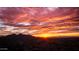 Dramatic sunset view over a city skyline with silhouetted mountains in the background at 25916 S 198Th St, Queen Creek, AZ 85142