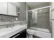Updated bathroom with gray mosaic tile, walk-in shower, and modern vanity at 2609 S Country Club Way, Tempe, AZ 85282
