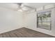 Bright bedroom with wood-look flooring, large window, and ceiling fan at 2609 S Country Club Way, Tempe, AZ 85282