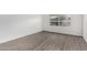 Simple bedroom with wood-look flooring and large window at 2609 S Country Club Way, Tempe, AZ 85282