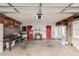 Garage with workbench, storage cabinets, and red doors at 2609 S Country Club Way, Tempe, AZ 85282
