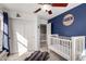 Charming bedroom with a crib, closet, and blue walls at 2838 E Shady Spring Trl, Phoenix, AZ 85024