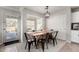 Charming dining area with a rustic wooden table and access to the backyard at 2838 E Shady Spring Trl, Phoenix, AZ 85024