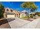 Two-story house with a tan facade, arched windows, and a three-car garage at 2838 E Shady Spring Trl, Phoenix, AZ 85024