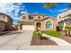Two-story house with a tan facade, arched windows, and a three-car garage at 2838 E Shady Spring Trl, Phoenix, AZ 85024