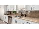 Modern kitchen features white cabinets, granite countertops, and a double sink at 2838 E Shady Spring Trl, Phoenix, AZ 85024