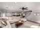 Bright living room featuring a large sectional sofa and views into the kitchen and upstairs at 2838 E Shady Spring Trl, Phoenix, AZ 85024