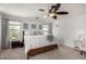 Bright main bedroom with carpeted floors, wooden bed frame, and ceiling fan at 2838 E Shady Spring Trl, Phoenix, AZ 85024