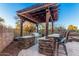 Outdoor kitchen with built-in grill, granite counters, and pergola at 2838 E Shady Spring Trl, Phoenix, AZ 85024