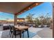 Covered patio with dining table and fire pit for outdoor living at 2838 E Shady Spring Trl, Phoenix, AZ 85024