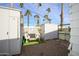 Small backyard with storage sheds and seating area at 305 S Val Vista Dr # 417, Mesa, AZ 85204