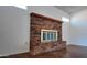 Brick fireplace with a glass door and a wooden mantle at 3054 W Tierra Buena Ln, Phoenix, AZ 85053