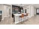 Modern kitchen with a breakfast bar, stainless steel appliances, and dark cabinets at 31310 N 26Th Dr, Phoenix, AZ 85085