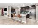Open concept kitchen boasting an island, stainless steel appliances, and a breakfast bar at 31310 N 26Th Dr, Phoenix, AZ 85085