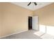 Well-lit bedroom with ceiling fan and access to another room at 38913 N 21St Ave, Phoenix, AZ 85086