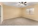 Bright bedroom with ceiling fan and large window at 38913 N 21St Ave, Phoenix, AZ 85086