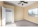 Spacious bedroom with a ceiling fan and window at 38913 N 21St Ave, Phoenix, AZ 85086
