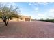 Tan stucco house with brown garage door, stone pathway, and gravel yard at 38913 N 21St Ave, Phoenix, AZ 85086