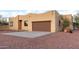 Front view of a single-story home with a brown exterior and a two-car garage at 38913 N 21St Ave, Phoenix, AZ 85086