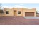 Tan stucco house with brown garage door, stone pathway, and gravel yard at 38913 N 21St Ave, Phoenix, AZ 85086