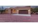 Tan stucco house with brown garage door, stone pathway, and gravel yard at 38913 N 21St Ave, Phoenix, AZ 85086