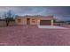 Tan stucco house with brown garage door, stone pathway, and gravel yard at 38913 N 21St Ave, Phoenix, AZ 85086