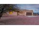 Tan stucco house with brown garage door, stone pathway, and gravel yard at 38913 N 21St Ave, Phoenix, AZ 85086