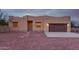 Tan stucco house with brown garage door, and gravel yard at 38913 N 21St Ave, Phoenix, AZ 85086