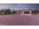 Tan stucco house with brown garage door, and gravel yard at 38913 N 21St Ave, Phoenix, AZ 85086