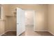 Hallway with tile flooring and access to laundry room at 38913 N 21St Ave, Phoenix, AZ 85086