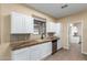 Kitchen with white cabinets, granite countertops, and stainless steel appliances at 38913 N 21St Ave, Phoenix, AZ 85086