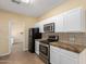 Kitchen features white cabinets, granite countertops, and stainless steel appliances at 38913 N 21St Ave, Phoenix, AZ 85086