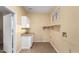 Laundry room with white cabinets and shelving at 38913 N 21St Ave, Phoenix, AZ 85086